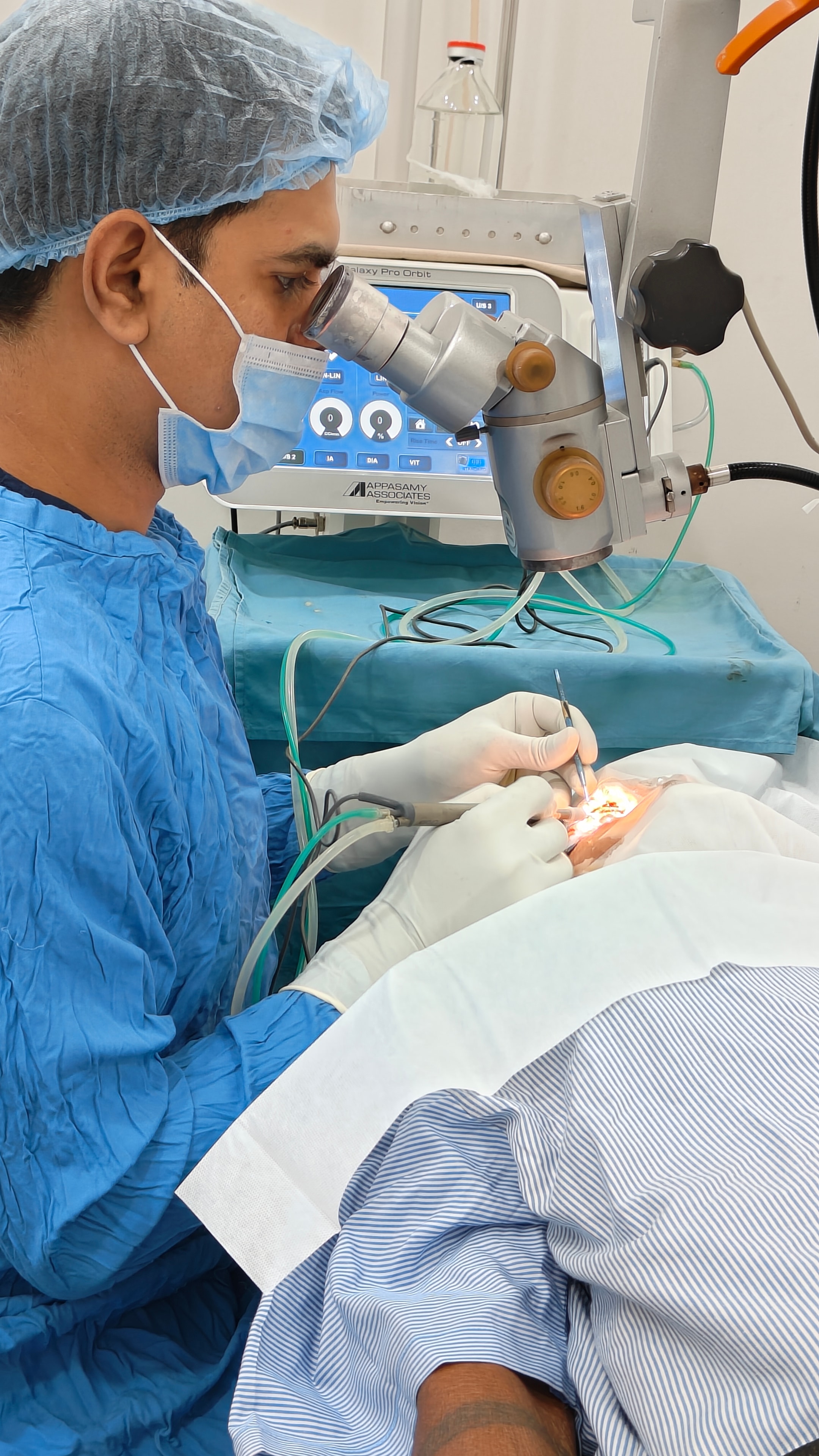 Dr. Vishwakarma performing cataract surgery under operating microscope